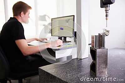 Male Engineer Using CAD System To Work On Component Stock Photo