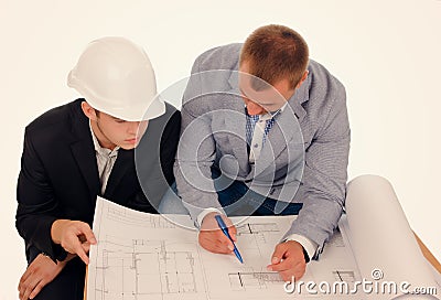 Male Engineers Discussing Design from Blueprint Stock Photo