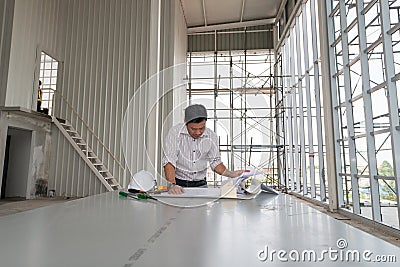 Male engineers are standing watch model in building construction Stock Photo