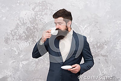 Male fashion model. Mature businessman. elegant man with beard drink coffee. Brutal bearded hipster in formal suit Stock Photo