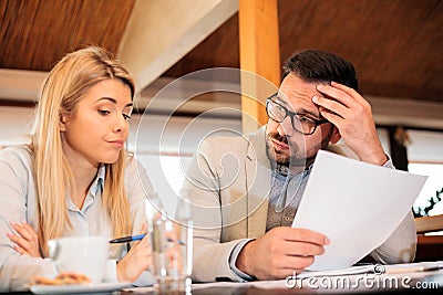 Male and female business people facing problems during a meeting Stock Photo