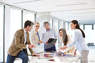 Male and female design professionals having discussion at table in new office Stock Photo