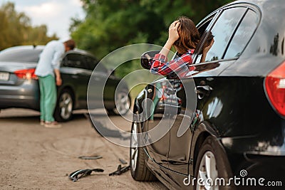 Male and female drivers after car accident on road Stock Photo