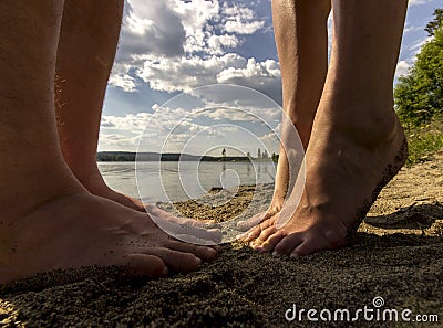 Male and Female Feet in Sand Stock Photo