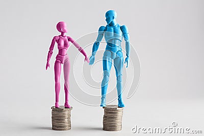 Male and female figurines holding hands looking at eachother, st Stock Photo