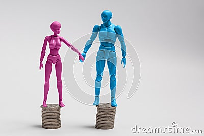 Male and female figurines holding hands and standing on top of e Stock Photo