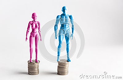 Male and female figurines standing next to equal piles of coins. Stock Photo