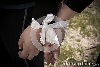 Two hands tied by a ribbon Stock Photo