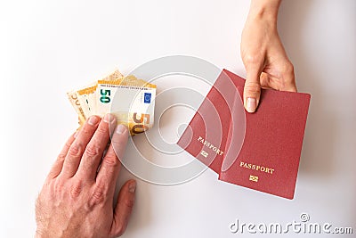 Male and female hands with passport and money on white background Stock Photo