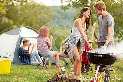 Male and female lovingly look each other while baked barbecue Stock Photo