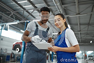 Male and female mechanics, car service Stock Photo