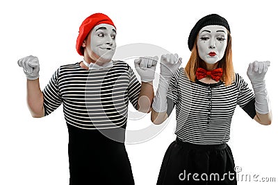 Male and female mimes showing a pantomime, leaning on imaginary walls Stock Photo