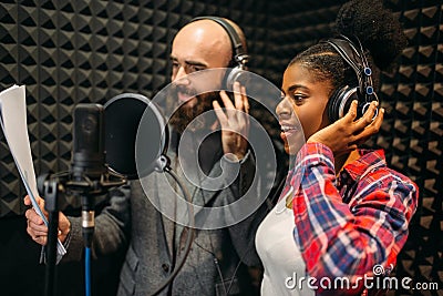 Male and female singers in audio recording studio Stock Photo