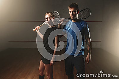 Male and female squash game players with rackets Stock Photo