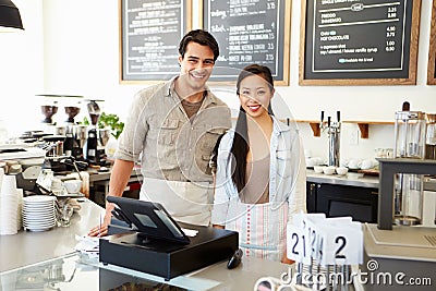 Male And Female Staff In Coffee Shop Stock Photo