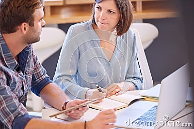 Male and female students brainstorming together for a colledge project Stock Photo