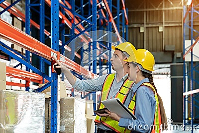 Male and Female Supervisors Hold document is checking the number of items in the warehouse that he is responsible for. checking Stock Photo