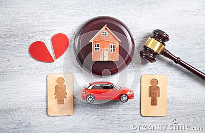 Male and female wooden symbols, gavel, house, car, broken heart and judge gavel Stock Photo