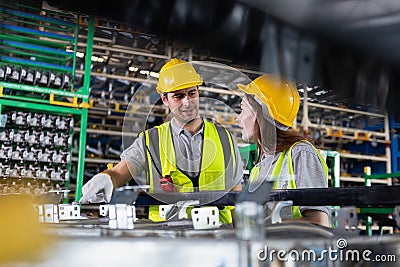 Male and Female worker inspect goods auto parts on shelves in warehouse. logistic import export auto parts. Checklist stock Stock Photo