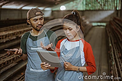 male and female worker worried looking at reports on tablet Stock Photo