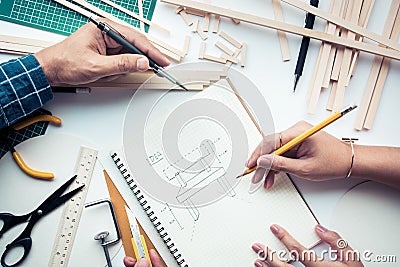 Male and female working on worktable with wood material.Diy Stock Photo