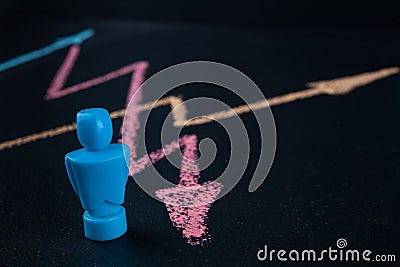 Male figurine with line graph drawin with chalk. Stock Photo