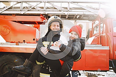 Male firefighter rescued a child and a toy Stock Photo