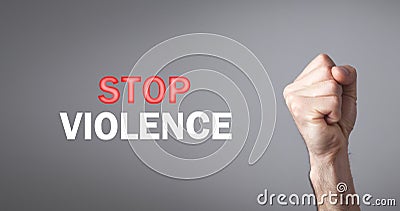 Male fist. Stop Violence text on gray background Stock Photo