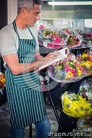 Male florist checking checklist Stock Photo