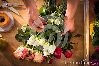 Male florist preparing flower bouquet Stock Photo