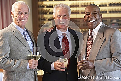 Male Friends Socializing At A Bar Stock Photo