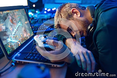 Male gamer sleeping at his laptop after challenge Stock Photo