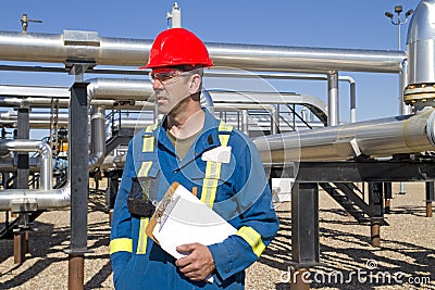 Male gas field operator inspects compressor site Stock Photo