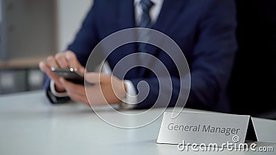 Male general manager of corporation reading business e-mail on smartphone Stock Photo