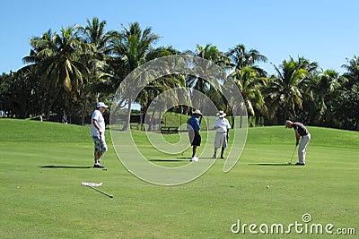 Male golf player making his putt with foursome Editorial Stock Photo