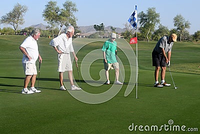 Male golfers on putting green. Editorial Stock Photo