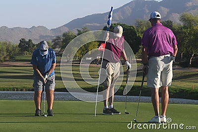 Male golfers on putting green. Editorial Stock Photo