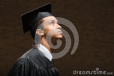 Male graduate looking up Stock Photo