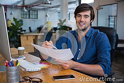 Male graphic designer at desk Stock Photo