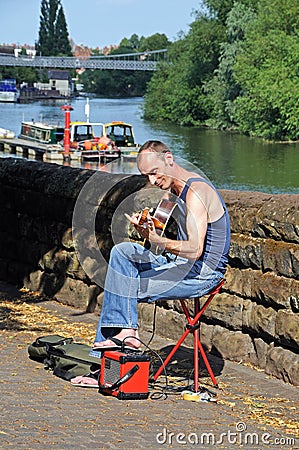 Male guitarist busking, Chester. Editorial Stock Photo