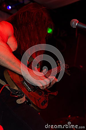 Male guitarist in a rock band performing live Stock Photo