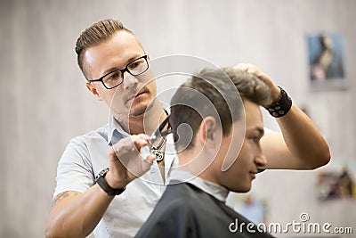 Male hairdresser making haircut Stock Photo