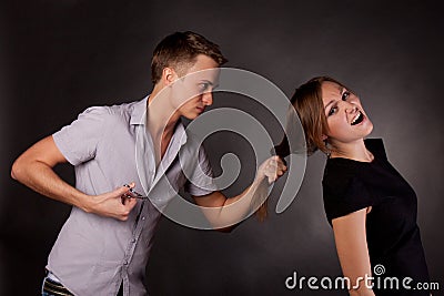 Male hairdresser maniac, mocks a woman Stock Photo