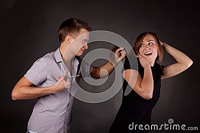 Male hairdresser maniac, mocks a woman Stock Photo