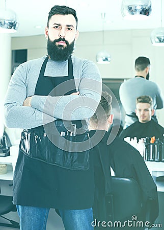 Male hairdresser showing his workplace and tools at hair salon Stock Photo