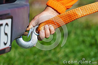 Male hand attaching towline to car Stock Photo