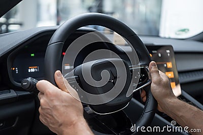 male hand on Driver's column, Behind steering wheel Polestar 2 electric car, modern passenger car Editorial Stock Photo