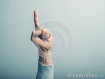 Male hand with finger pointing up Stock Photo