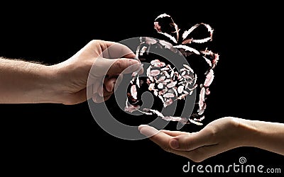 The male hand gives the woman the gift box be made of bird feathers with heart inside. Stock Photo