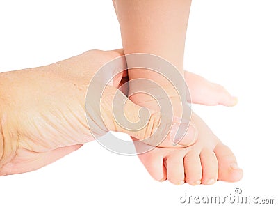 Male hand holding firmly around a foot of toddler isolated Stock Photo